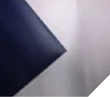 Close-up of a dark paint booth wall panel corner against a white background