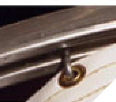 Close-up of a screw fastened into a piece of wood material