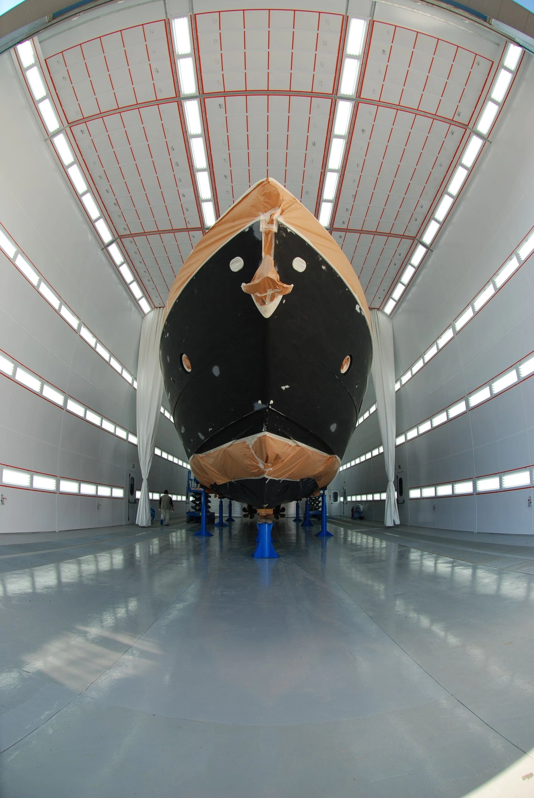 Ferretti yacht in a marine paint booth