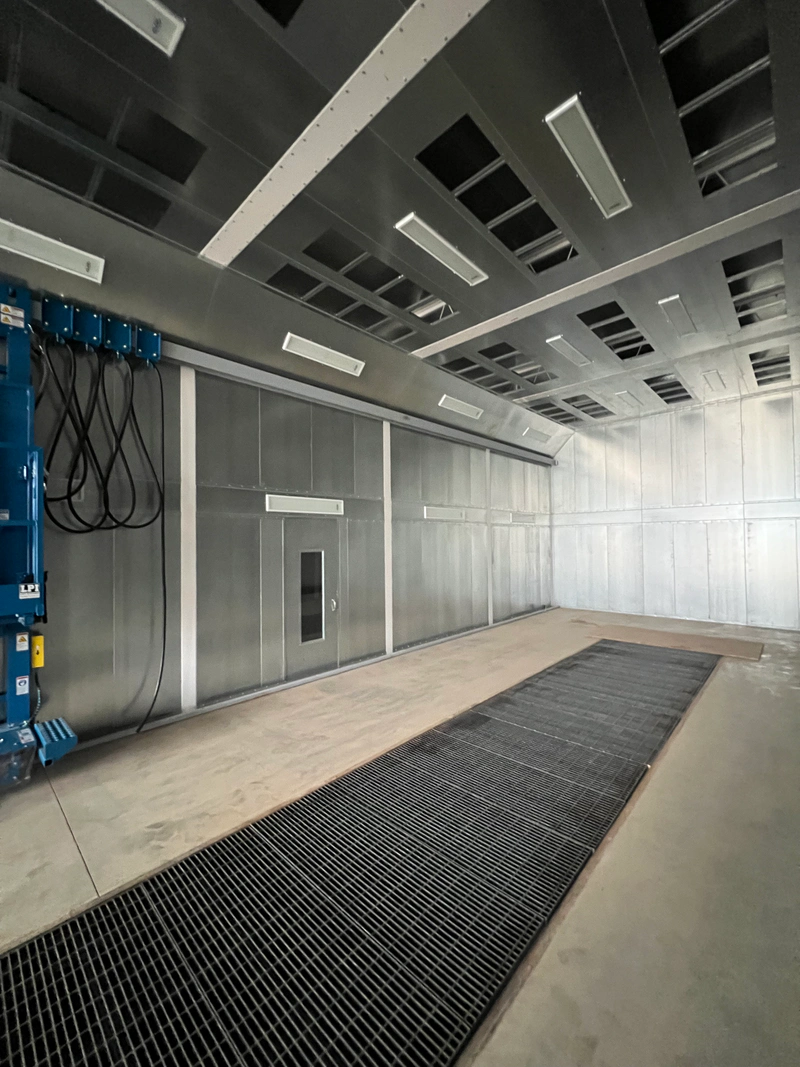 Full downdraft truck paint booth interior with floor exhaust grating