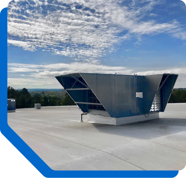 Industrial rooftop ventilation unit on a flat roof under a blue sky