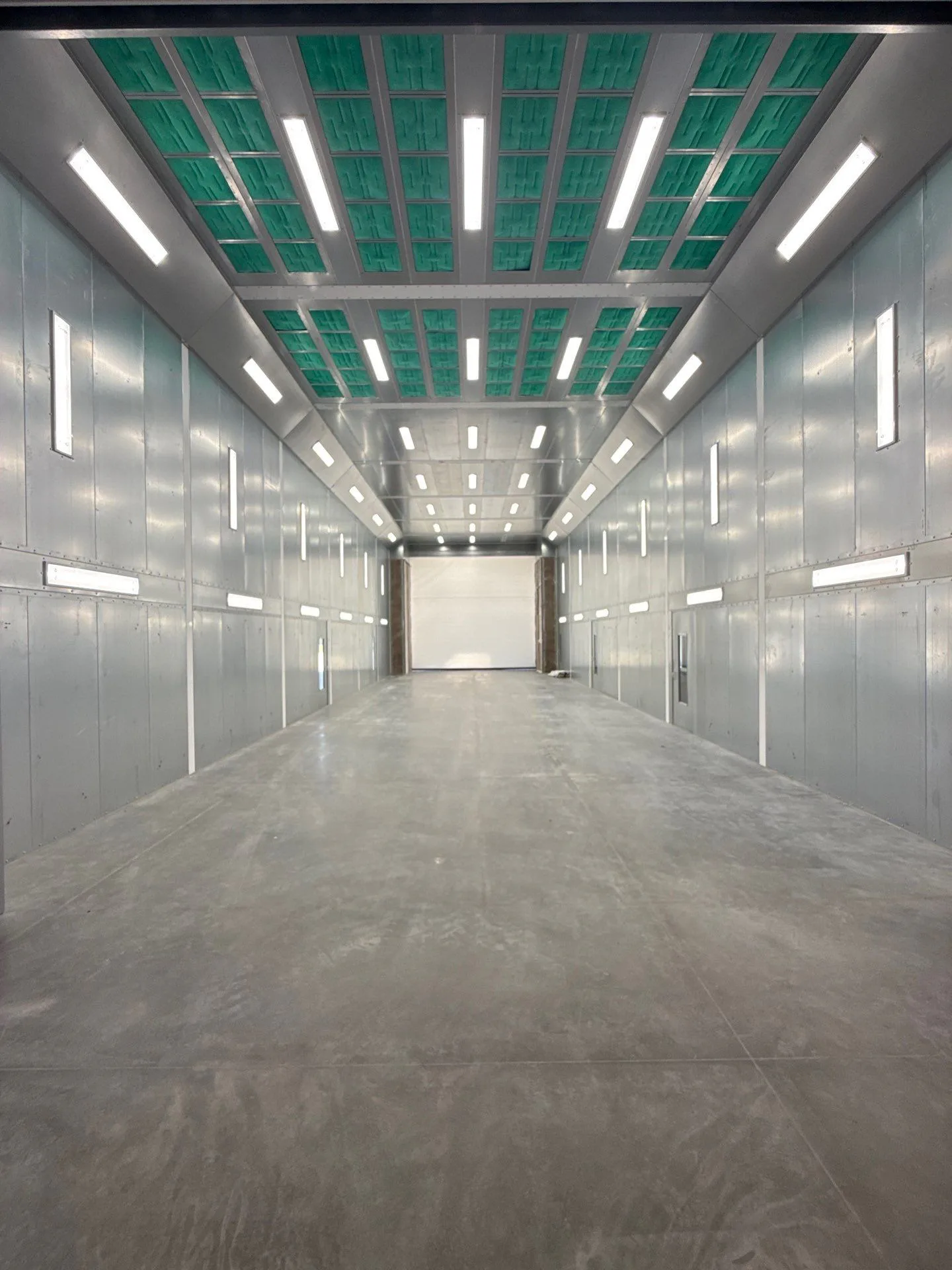 Modular paint booth enclosure used as a featured image for comparing curtain and hard-wall booth setups