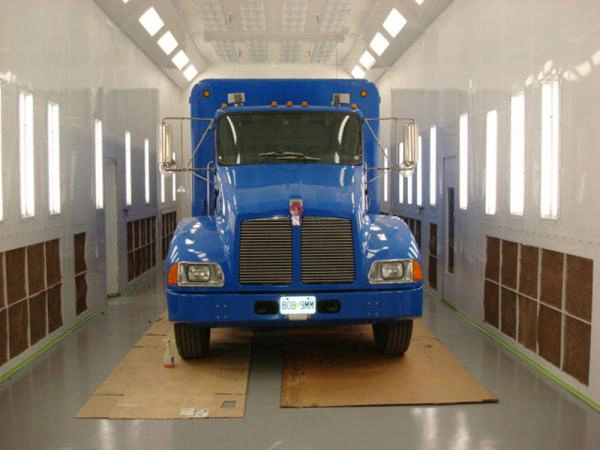 Side downdraft truck paint booth interior with a blue truck
