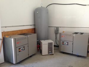 Two Nottrol AC 7 air compressors with an air dryer unit and tank in a workshop