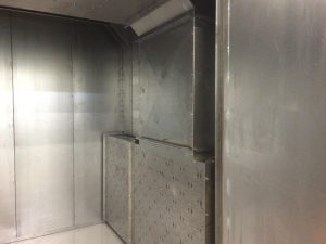 Industrial metal ventilation and exhaust system inside a paint booth