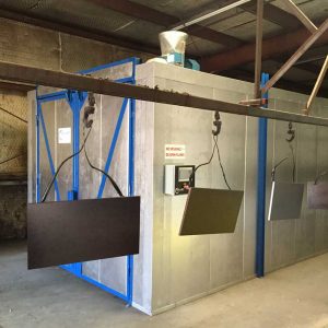 Industrial paint booth with hanging panels for spray painting
