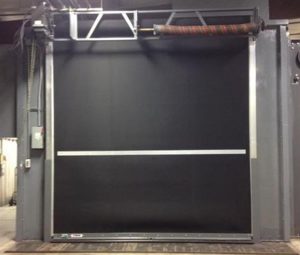 Industrial black high-speed roll-up door with metal frame in factory