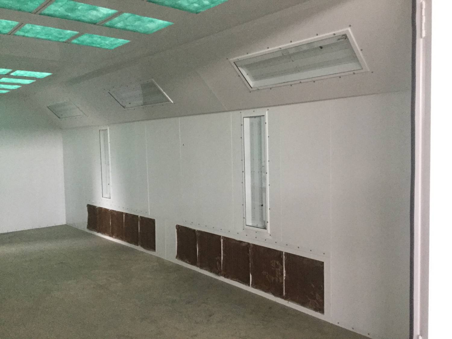 Interior of a modern paint booth with ventilation system.