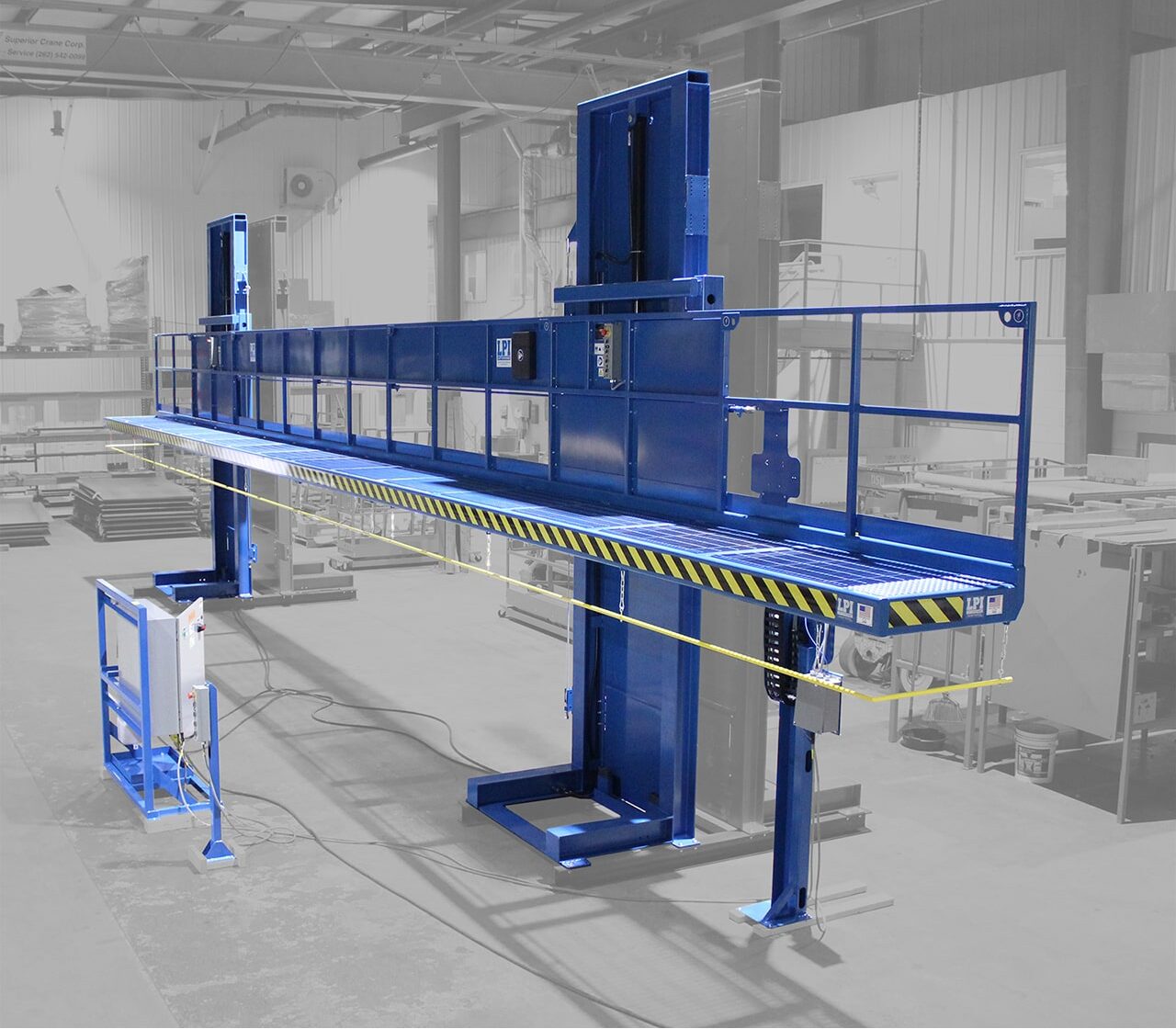 Advanced industrial paint booth with blue lift platform.