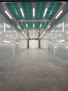 Modular paint booth enclosure used as a featured image for comparing curtain and hard-wall booth setups